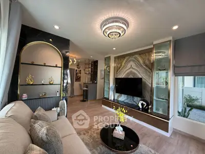 Luxurious living room with elegant decor and modern lighting, featuring a stylish TV wall and cozy seating area.