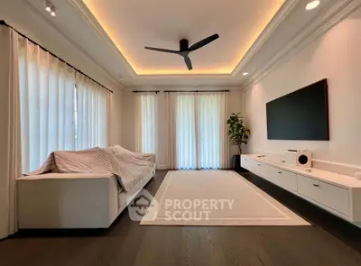 Spacious modern living room with elegant ceiling lights and sleek entertainment setup