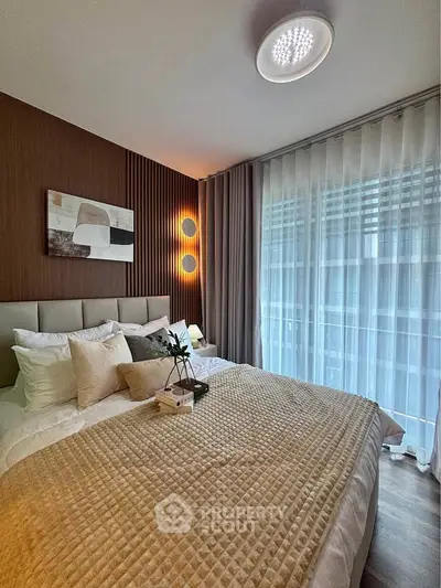 Luxurious bedroom with modern decor, plush bedding, and floor-to-ceiling windows for natural light.