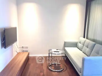 Modern living room with sleek sofa and wall-mounted TV, perfect for cozy relaxation.