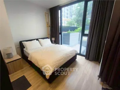 Modern bedroom with large window and garden view in urban apartment