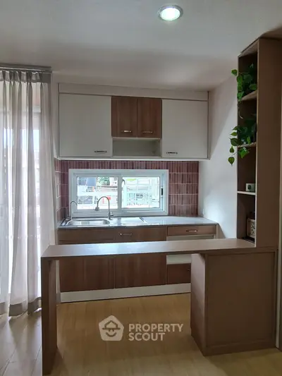 Modern kitchen with wooden cabinets and open layout design