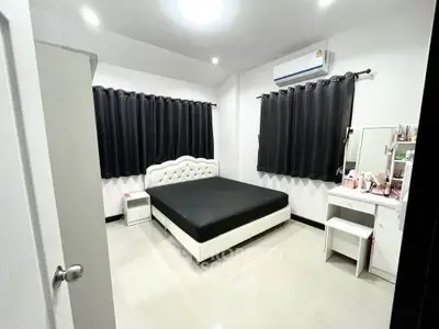 Modern bedroom with sleek design, featuring a comfortable bed and stylish decor.