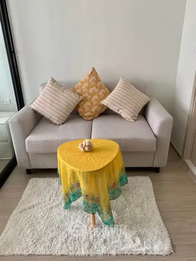 Cozy living room with stylish sofa and vibrant decor in modern apartment