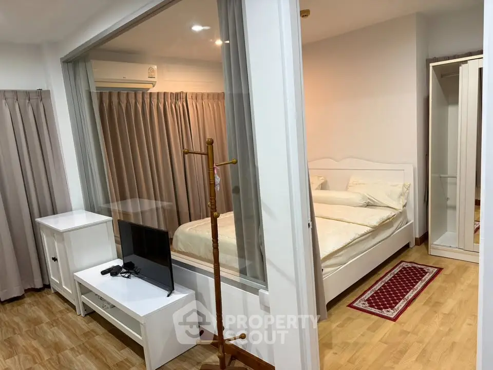 Modern bedroom with glass partition and cozy decor in stylish apartment