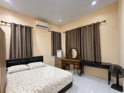 Cozy bedroom with elegant furniture and air conditioning, perfect for relaxation.