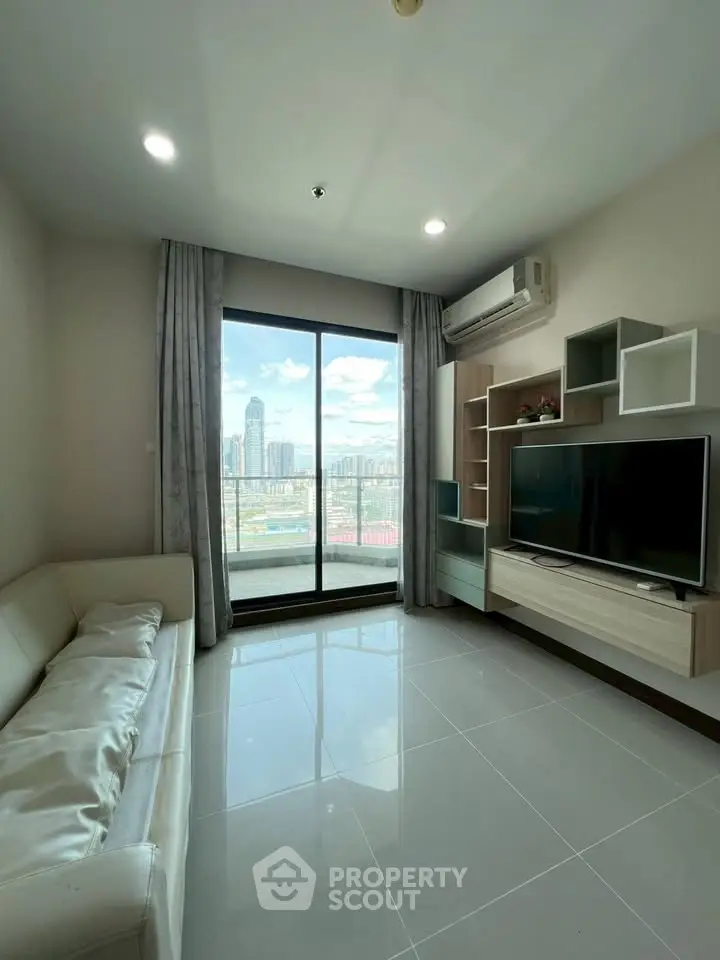 Modern living room with city view, sleek furniture, and large window for natural light.