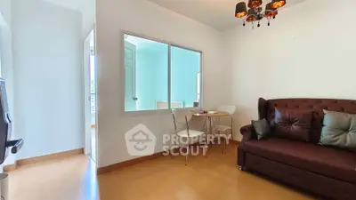 Cozy living room with elegant chandelier and modern furniture in a bright apartment.