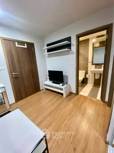 Modern apartment interior with wooden flooring and sleek bathroom view