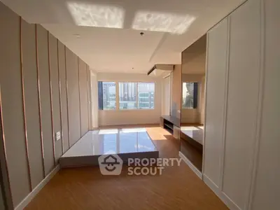 Spacious modern living room with large windows and elegant wooden flooring