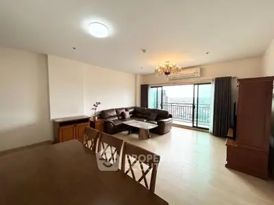 Spacious living room with elegant chandelier and balcony view in modern apartment