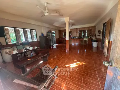 Spacious open-layout kitchen with rustic wooden furniture and tiled flooring