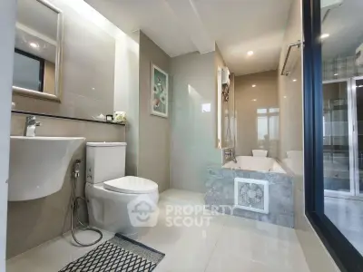Modern bathroom with sleek fixtures and a luxurious bathtub in a contemporary apartment.