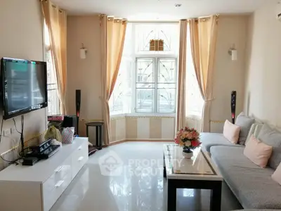 Bright and cozy living room with modern decor and large windows