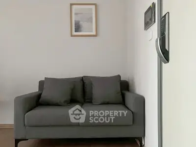 Modern living room with stylish gray sofa and minimalistic decor
