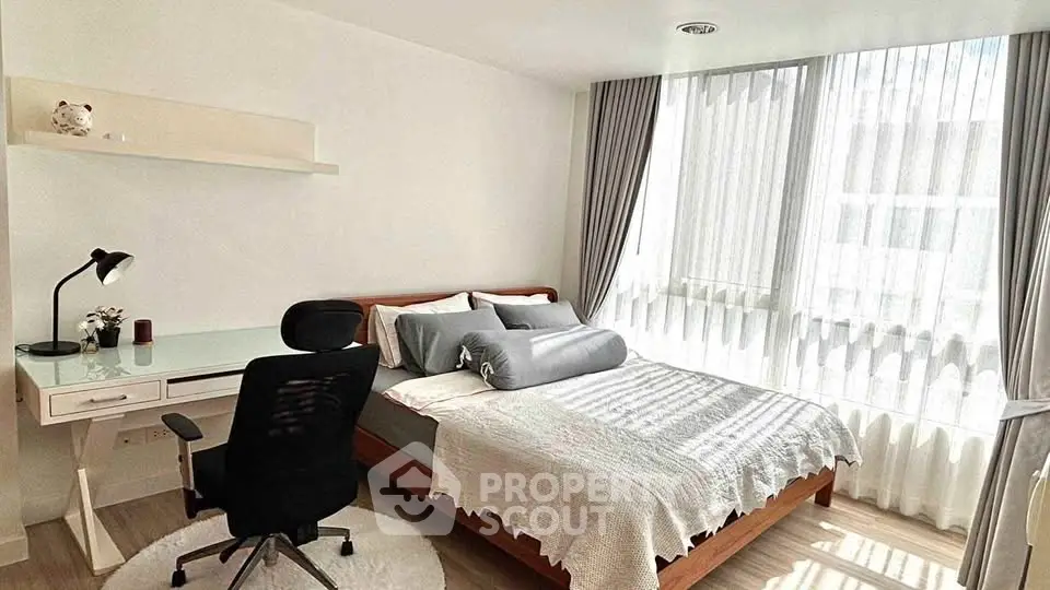 Bright and modern bedroom with large window and stylish decor
