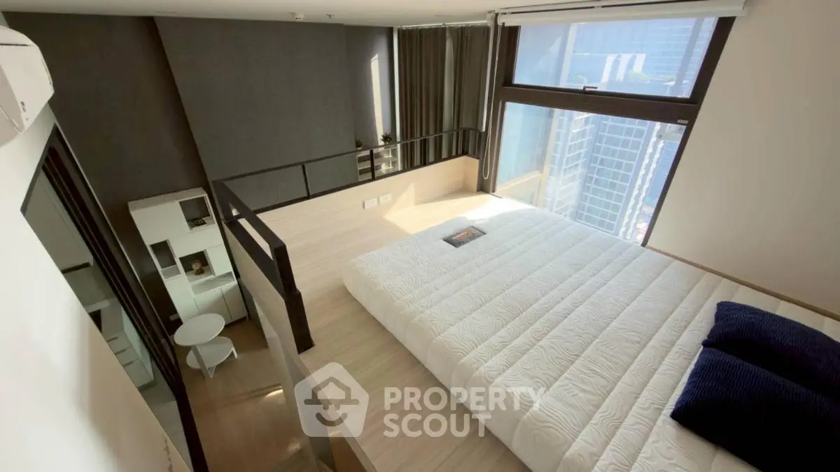 Modern loft bedroom with city view and stylish decor