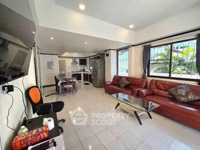 Spacious living room with modern furniture and open kitchen layout