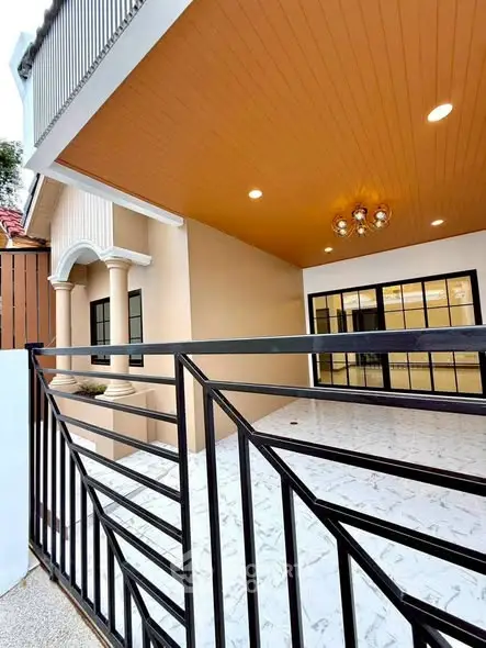 Modern house entrance with elegant lighting and spacious balcony