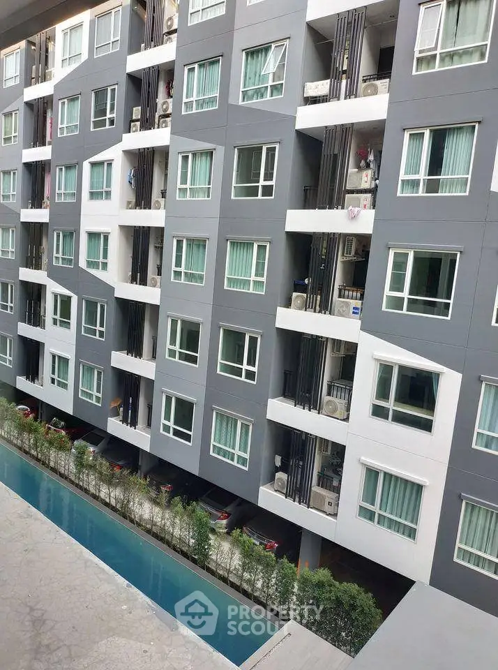 Modern apartment building with pool view and balconies, perfect for urban living.