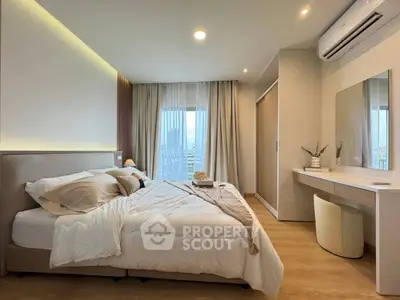 Elegant bedroom with modern decor, featuring a cozy bed, stylish vanity, and natural light from large windows.