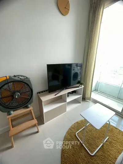 Modern living room with TV, fan, and balcony view