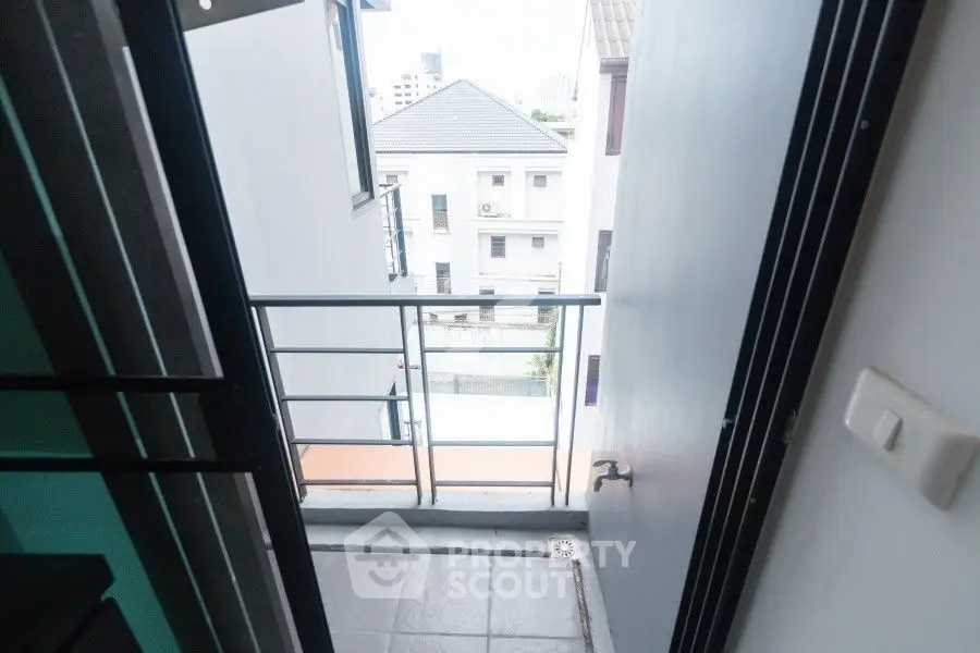Charming small balcony with urban view, perfect for city living enthusiasts.