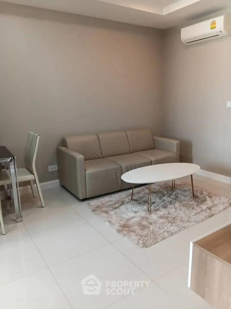 Modern living room with sleek sofa and stylish coffee table in a cozy apartment.