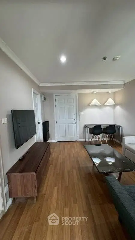 Modern living room with sleek furniture and wooden flooring, ideal for contemporary living.