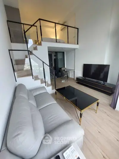 Modern duplex living room with sleek staircase and stylish furniture