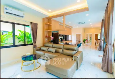 Luxurious open-layout living room with modern kitchen and elegant decor