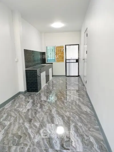 Modern kitchen with sleek black tiles and glossy marble floor