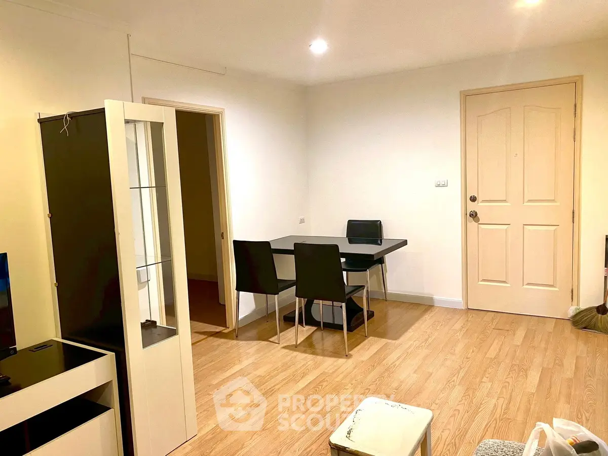 Modern apartment interior with dining area and wooden flooring