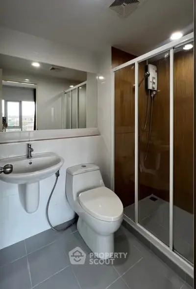 Modern bathroom with sleek shower and contemporary fixtures in a stylish apartment.