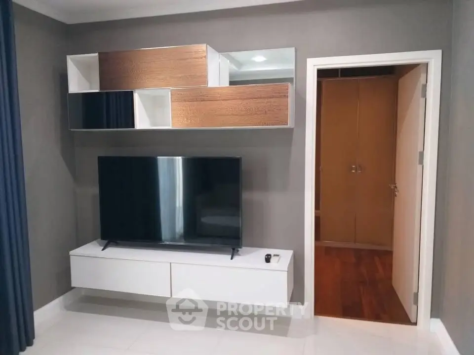Modern living room with sleek TV setup and stylish shelving