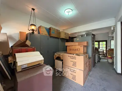 Spacious storage room filled with boxes and cabinets, ideal for organizing and decluttering.