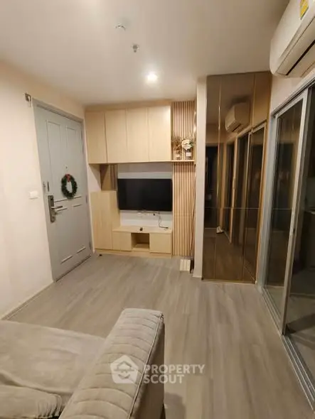 Modern living room with sleek design and cozy ambiance, featuring a TV unit and stylish decor.