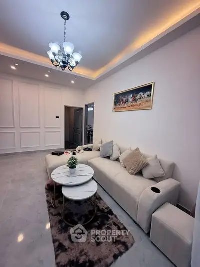 Elegant living room with modern chandelier and cozy sofa