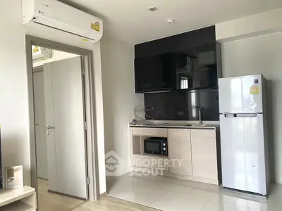 Modern compact kitchen with sleek appliances and minimalist design