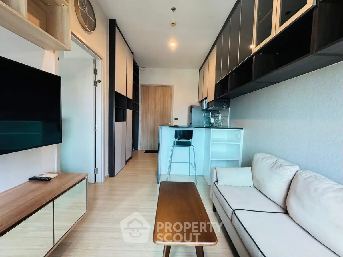 Modern living room with sleek design and open kitchen layout