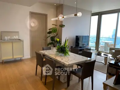 Luxurious open-plan living and dining area with city view, modern decor, and elegant furnishings.