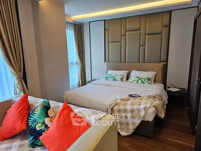 Luxurious bedroom with elegant decor and cozy bedding in modern apartment.
