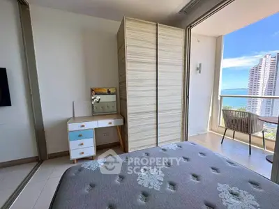 Modern bedroom with balcony offering stunning ocean view in high-rise apartment