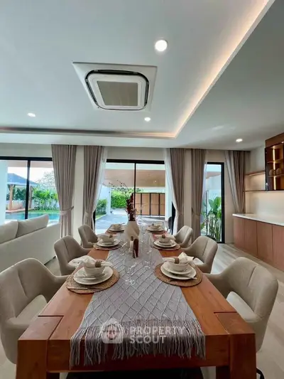 Luxurious dining area with elegant table setting and pool view, perfect for entertaining.
