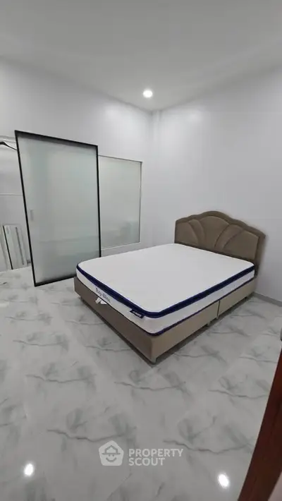 Spacious bedroom with modern design and comfortable bed in a stylish apartment.