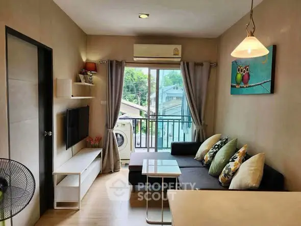 Charming living room with balcony view, modern decor, and natural light, perfect for cozy urban living.