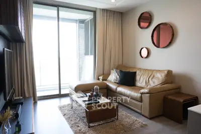 Modern living room with leather sofa and balcony view, perfect for relaxation.