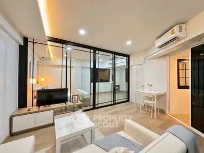 Modern living room with glass partition and cozy decor