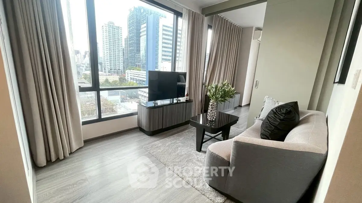 Modern living room with city view, featuring sleek furniture and large windows.