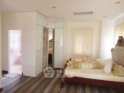 Spacious bedroom with elegant decor and attached bathroom
